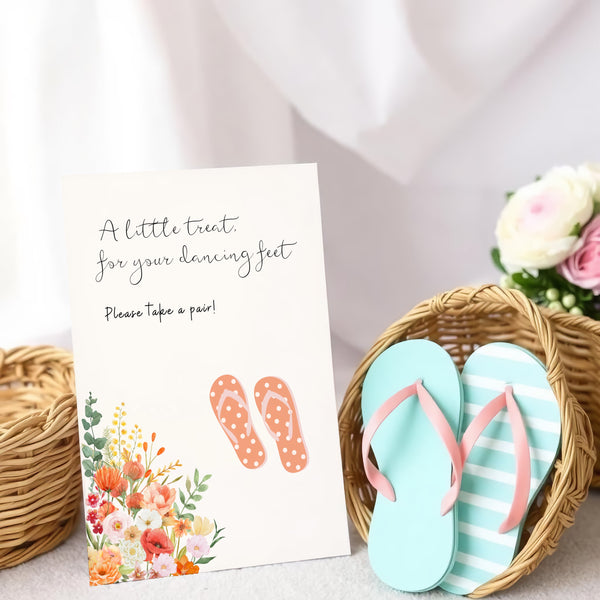 A stylish wedding sign reading "A little treat for your dancing feet, please take a pair", displayed next to a basket of flip-flops for guests. The design features elegant typography, perfect for a wedding reception.