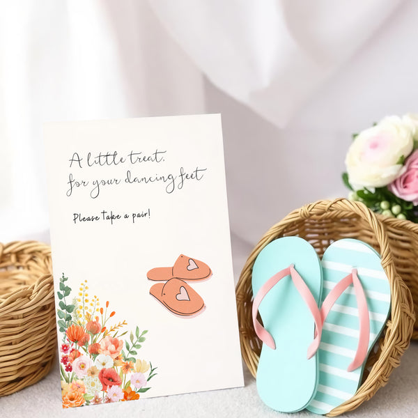 A stylish wedding sign reading "A little treat for your dancing feet, please take a pair", displayed next to a basket of flip-flops for guests. The design features elegant typography, perfect for a wedding reception.