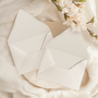 A flat lay of elegant wedding invitation envelopes, partially open to reveal beautifully designed envelope liners in various styles, including floral, modern, and classic patterns. The envelope inserts add a touch of luxury and sophistication to the stationery set.