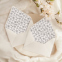 A flat lay of elegant wedding invitation envelopes, partially open to reveal beautifully designed envelope liners in various styles, including floral, modern, and classic patterns. The envelope inserts add a touch of luxury and sophistication to the stationery set.