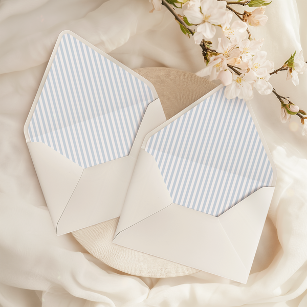 A flat lay of elegant wedding invitation envelopes, partially open to reveal beautifully designed envelope liners in various styles, including floral, modern, and classic patterns. The envelope inserts add a touch of luxury and sophistication to the stationery set.