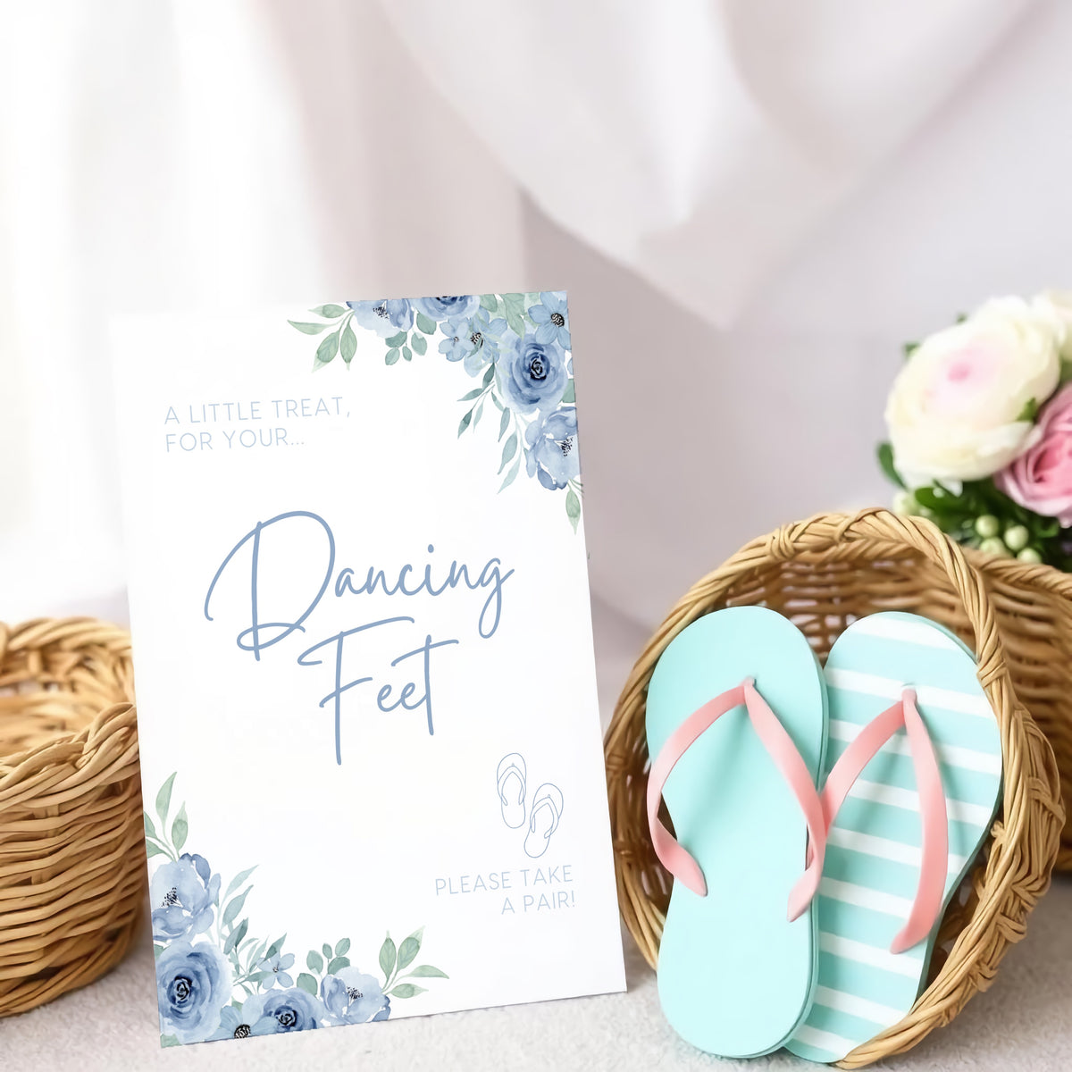 A stylish wedding sign reading "A little treat for your dancing feet, please take a pair", displayed next to a basket of flip-flops for guests. The design features elegant typography, perfect for a wedding reception.