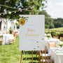 Personalised Christening Welcome Sign – A beautifully designed welcome sign featuring the baby’s name and event details, displayed on an easel at a christening venue.