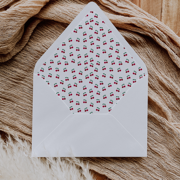 A flat lay of elegant wedding invitation envelopes, partially open to reveal beautifully designed envelope liners in various styles, including floral, modern, and classic patterns. The envelope inserts add a touch of luxury and sophistication to the stationery set.