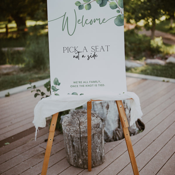 eucalyptus pick a seat not a side wedding ceremony sign - a personalised "pick  seat, not a side" wedding welcome sign, with a crisp white background and elegant green text, adorned with eucalyptus foliage