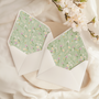 A flat lay of elegant wedding invitation envelopes, partially open to reveal beautifully designed envelope liners in various styles, including floral, modern, and classic patterns. The envelope inserts add a touch of luxury and sophistication to the stationery set.