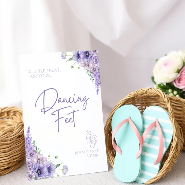 A stylish wedding sign reading "A little treat for your dancing feet, please take a pair", displayed next to a basket of flip-flops for guests. The design features elegant typography, perfect for a wedding reception.