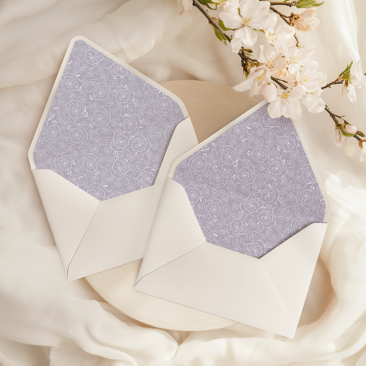 A flat lay of elegant wedding invitation envelopes, partially open to reveal beautifully designed envelope liners in various styles, including floral, modern, and classic patterns. The envelope inserts add a touch of luxury and sophistication to the stationery set.