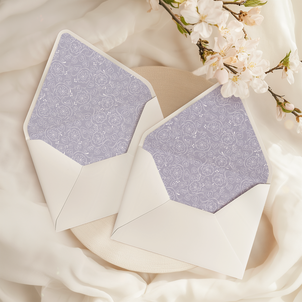 A flat lay of elegant wedding invitation envelopes, partially open to reveal beautifully designed envelope liners in various styles, including floral, modern, and classic patterns. The envelope inserts add a touch of luxury and sophistication to the stationery set.