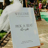 Minimalist wedding pick a seat, not a side ceremony sign - personalised wedding ceremony welcome sign, in a minimalist design, featuring a chic off-white plain background, and elegant and delicate typography