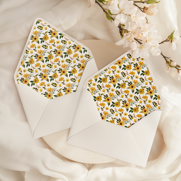 A flat lay of elegant wedding invitation envelopes, partially open to reveal beautifully designed envelope liners in various styles, including floral, modern, and classic patterns. The envelope inserts add a touch of luxury and sophistication to the stationery set.