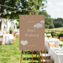 Personalised Christening Welcome Sign – A beautifully designed welcome sign featuring the baby’s name and event details, displayed on an easel at a christening venue.