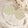 A flat lay of elegant wedding invitation envelopes, partially open to reveal beautifully designed envelope liners in various styles, including floral, modern, and classic patterns. The envelope inserts add a touch of luxury and sophistication to the stationery set.