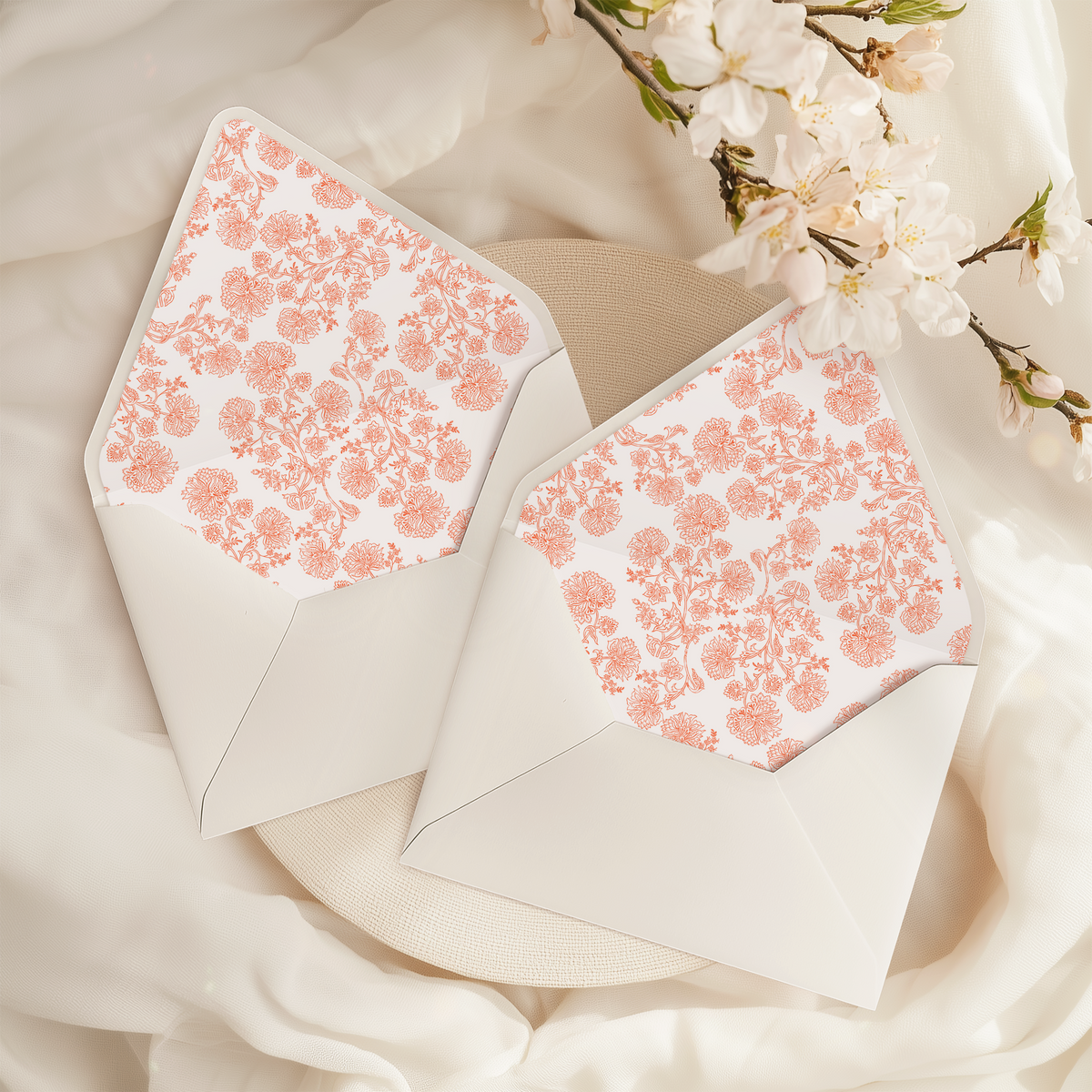 A flat lay of elegant wedding invitation envelopes, partially open to reveal beautifully designed envelope liners in various styles, including floral, modern, and classic patterns. The envelope inserts add a touch of luxury and sophistication to the stationery set.