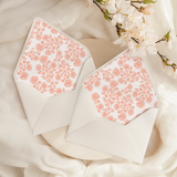 A flat lay of elegant wedding invitation envelopes, partially open to reveal beautifully designed envelope liners in various styles, including floral, modern, and classic patterns. The envelope inserts add a touch of luxury and sophistication to the stationery set.