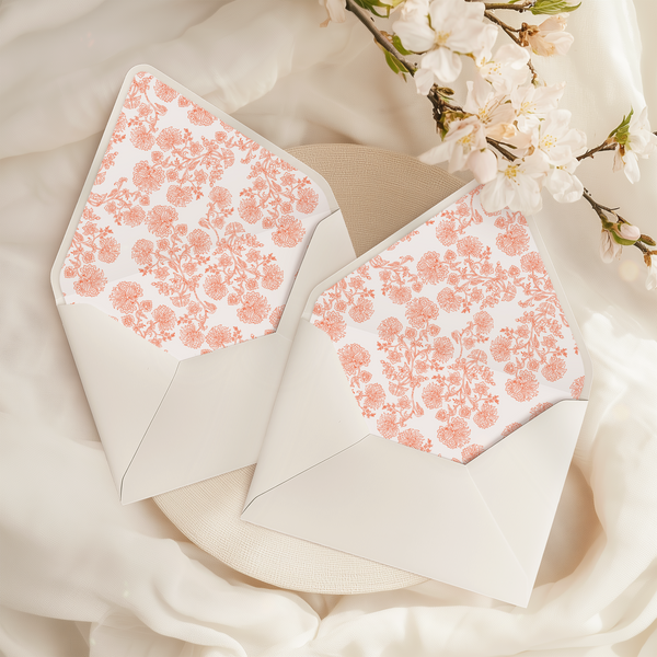 A flat lay of elegant wedding invitation envelopes, partially open to reveal beautifully designed envelope liners in various styles, including floral, modern, and classic patterns. The envelope inserts add a touch of luxury and sophistication to the stationery set.