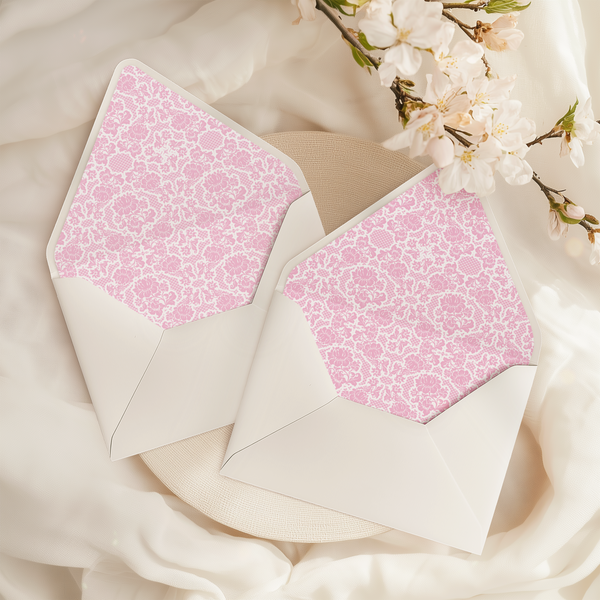 A flat lay of elegant wedding invitation envelopes, partially open to reveal beautifully designed envelope liners in various styles, including floral, modern, and classic patterns. The envelope inserts add a touch of luxury and sophistication to the stationery set.