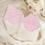 A flat lay of elegant wedding invitation envelopes, partially open to reveal beautifully designed envelope liners in various styles, including floral, modern, and classic patterns. The envelope inserts add a touch of luxury and sophistication to the stationery set.
