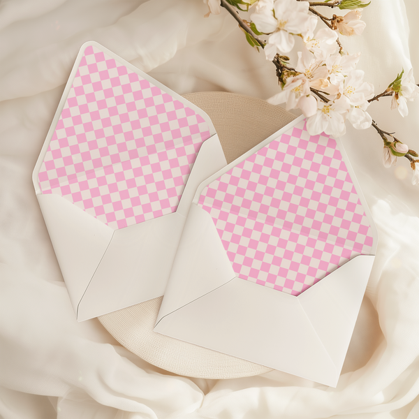 A flat lay of elegant wedding invitation envelopes, partially open to reveal beautifully designed envelope liners in various styles, including floral, modern, and classic patterns. The envelope inserts add a touch of luxury and sophistication to the stationery set.