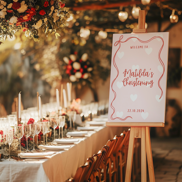 Personalised Christening Welcome Sign – A beautifully designed welcome sign featuring the baby’s name and event details, displayed on an easel at a christening venue.