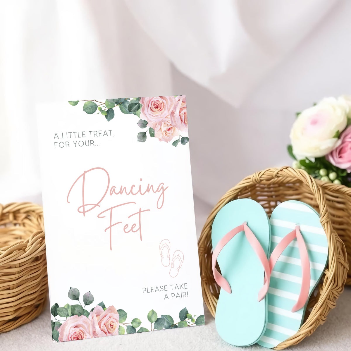 A stylish wedding sign reading "A little treat for your dancing feet, please take a pair", displayed next to a basket of flip-flops for guests. The design features elegant typography, perfect for a wedding reception.