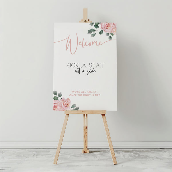 Pink Roses floral Pick a Seat Not a Side wedding ceremony sign - personalised wedding ceremony welcome sign, with a crisp white background, elegant blush pink typography, and adorned with sophisticated pink roses