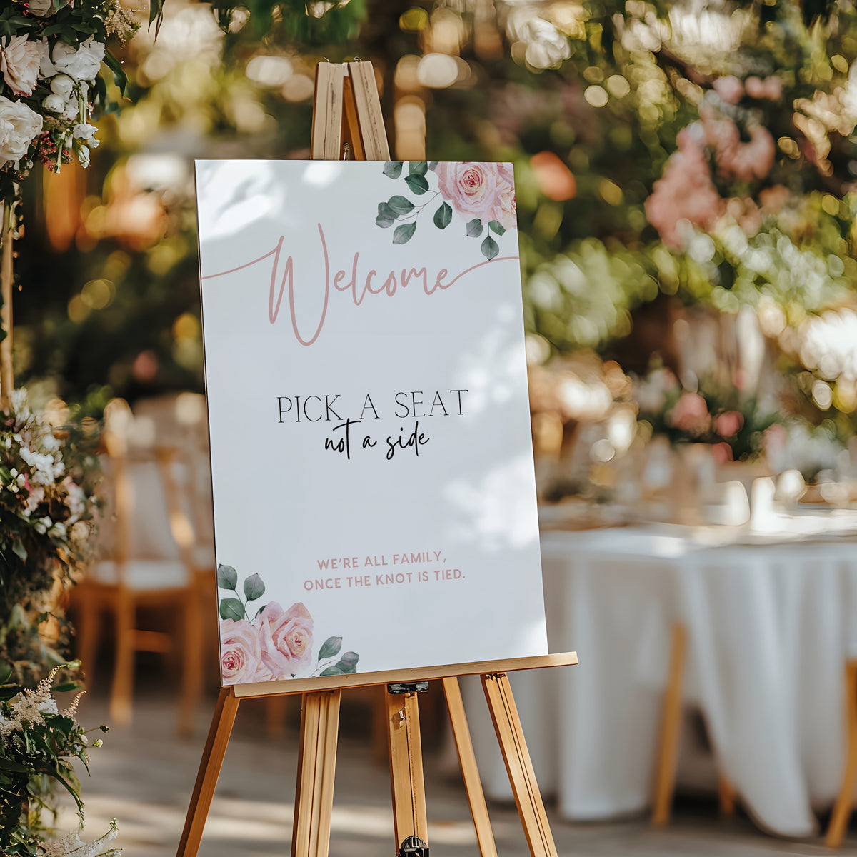 Pink Roses floral Pick a Seat Not a Side wedding ceremony sign - personalised wedding ceremony welcome sign, with a crisp white background, elegant blush pink typography, and adorned with sophisticated pink roses