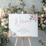 Pink Rose Floral wedding welcome sign in landscape orientation. A beautiful wedding welcome board, personalised with names and a date, adorned with pink roses and soft blush hues.