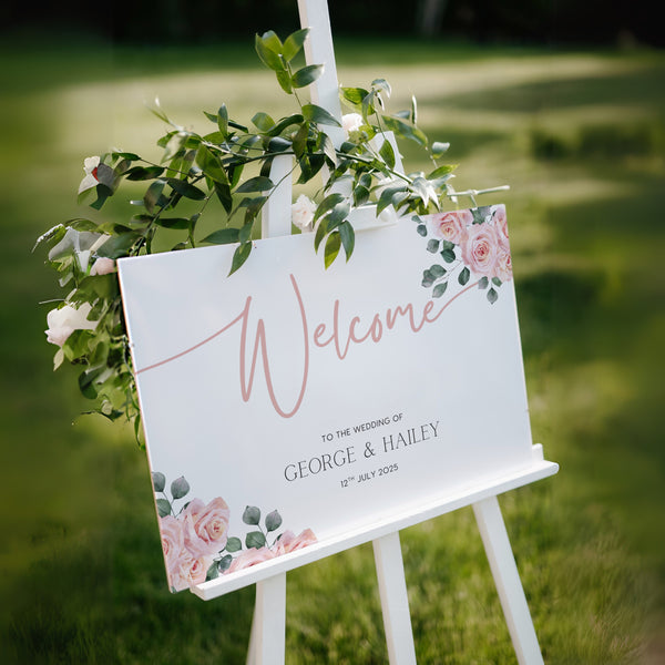 Pink Rose Floral wedding welcome sign in landscape orientation. A beautiful wedding welcome board, personalised with names and a date, adorned with pink roses and soft blush hues.