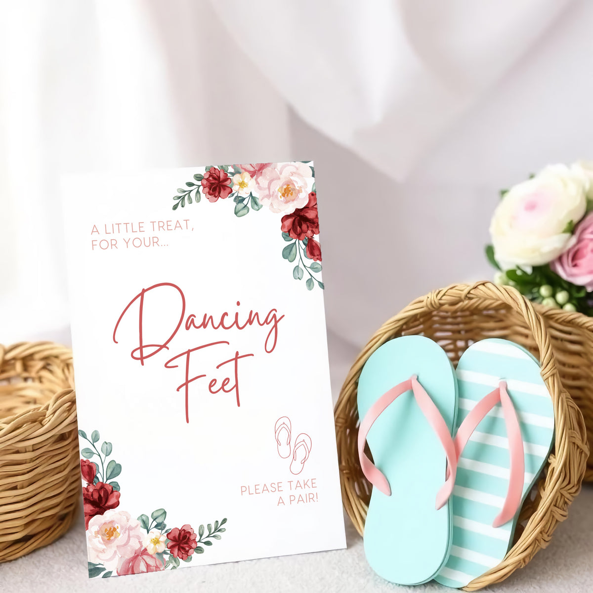 A stylish wedding sign reading "A little treat for your dancing feet, please take a pair", displayed next to a basket of flip-flops for guests. The design features elegant typography, perfect for a wedding reception.