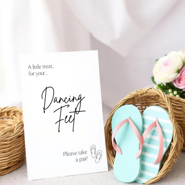 A stylish wedding sign reading "A little treat for your dancing feet, please take a pair", displayed next to a basket of flip-flops for guests. The design features elegant typography, perfect for a wedding reception.