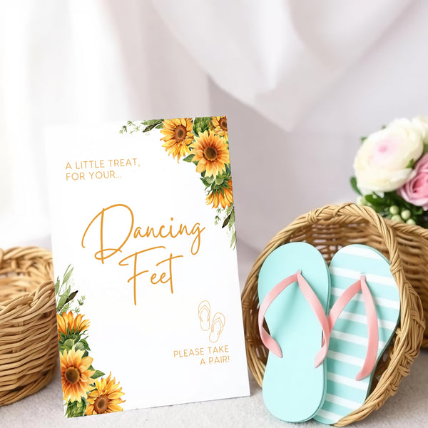 A stylish wedding sign reading "A little treat for your dancing feet, please take a pair", displayed next to a basket of flip-flops for guests. The design features elegant typography, perfect for a wedding reception.