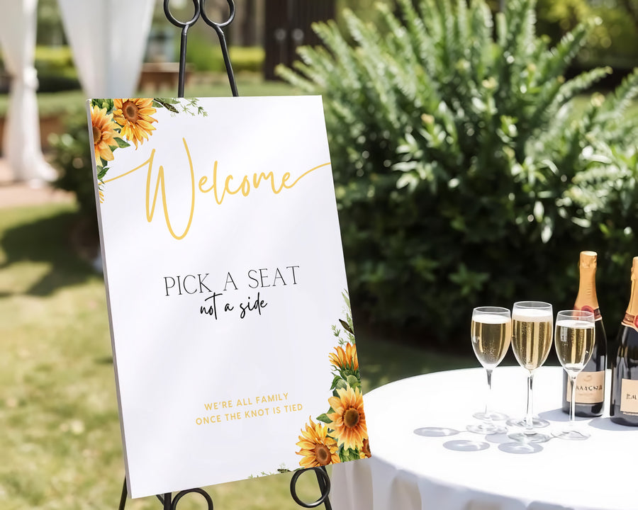 Sunflowers floral pick a seat not a side wedding ceremony sign - personalised pick a seat sign, with a crisp white background and an elegant yet joyful yellow typography, adorned with rustic and vibrant sunflowers.