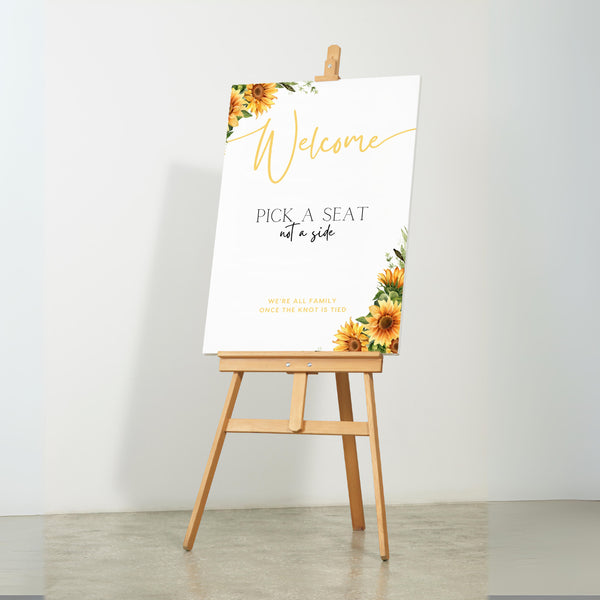 Sunflowers floral pick a seat not a side wedding ceremony sign - personalised pick a seat sign, with a crisp white background and an elegant yet joyful yellow typography, adorned with rustic and vibrant sunflowers.
