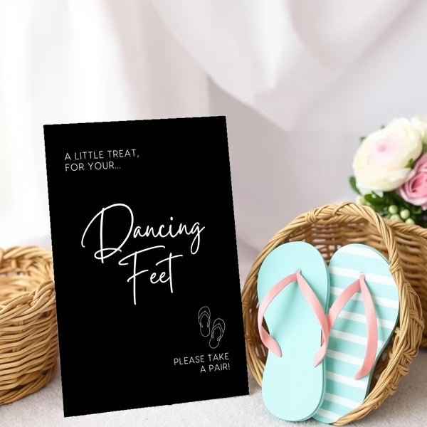 A stylish wedding sign reading "A little treat for your dancing feet, please take a pair", displayed next to a basket of flip-flops for guests. The design features elegant typography, perfect for a wedding reception.