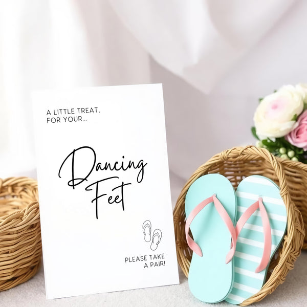 A stylish wedding sign reading "A little treat for your dancing feet, please take a pair", displayed next to a basket of flip-flops for guests. The design features elegant typography, perfect for a wedding reception.