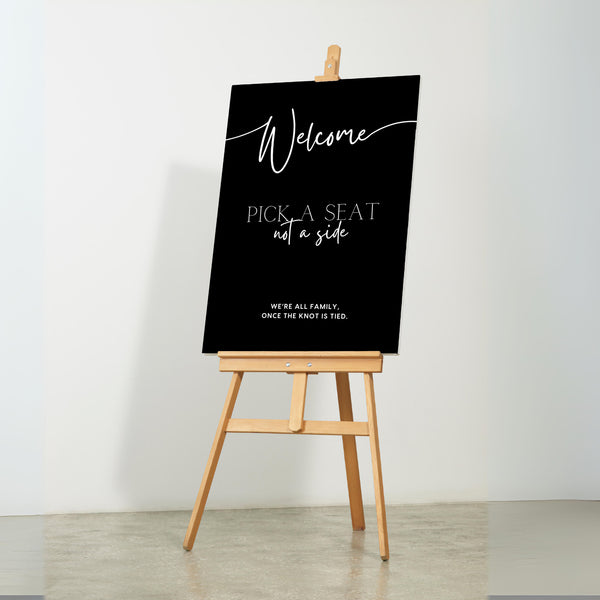 timeless black pick a seat not a side wedding welcome sign - personalised chic black wedding ceremony sign, featuring a bold black background, with elegant white typography, giving the ultimate classy-chic look.