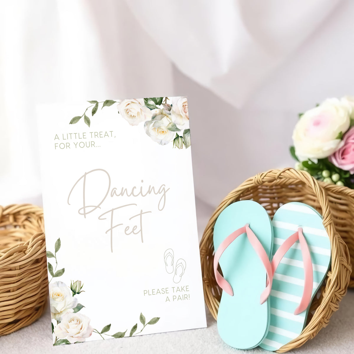 A stylish wedding sign reading "A little treat for your dancing feet, please take a pair", displayed next to a basket of flip-flops for guests. The design features elegant typography, perfect for a wedding reception.