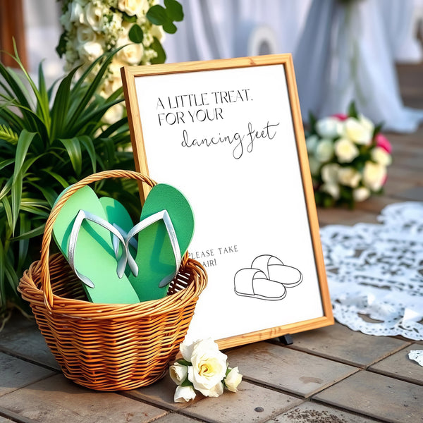 A stylish wedding sign reading "A little treat for your dancing feet, please take a pair", displayed next to a basket of flip-flops for guests. The design features elegant typography, perfect for a wedding reception.