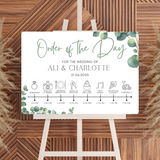 wedding order of the day sign featuring eucalyptus foliage