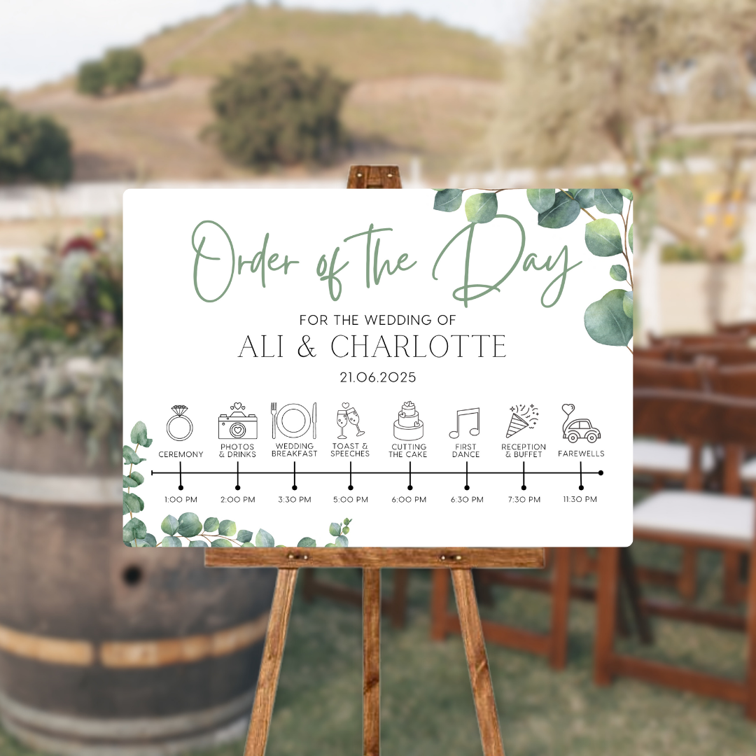 wedding order of the day sign featuring eucalyptus foliage