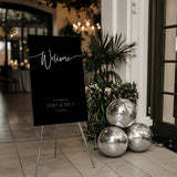 Black wedding welcome sign with custom details - a sleek black background with crisp white text, for a modern and sophisticated welcome to your special day