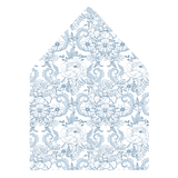 A flat lay of elegant wedding invitation envelopes, partially open to reveal beautifully designed envelope liners in various styles, including floral, modern, and classic patterns. The envelope inserts add a touch of luxury and sophistication to the stationery set.