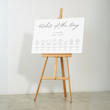 dreamy white order of the day wedding board, with sophisticated and delicate black text, in a calligraphy font