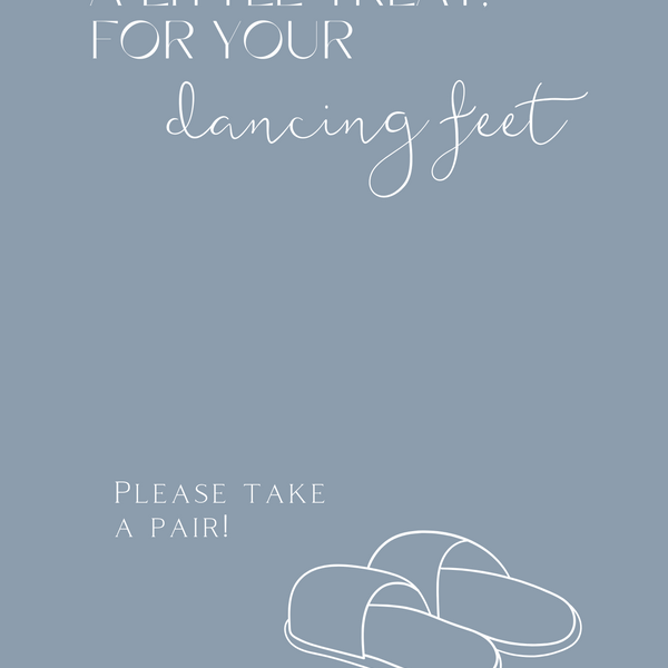 A stylish wedding sign reading "A little treat for your dancing feet, please take a pair", displayed next to a basket of flip-flops for guests. The design features elegant typography, perfect for a wedding reception.