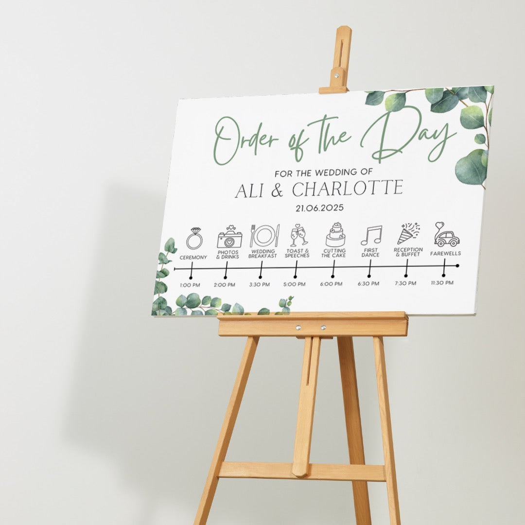 wedding order of the day sign featuring eucalyptus foliage