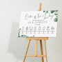 wedding order of the day sign featuring eucalyptus foliage