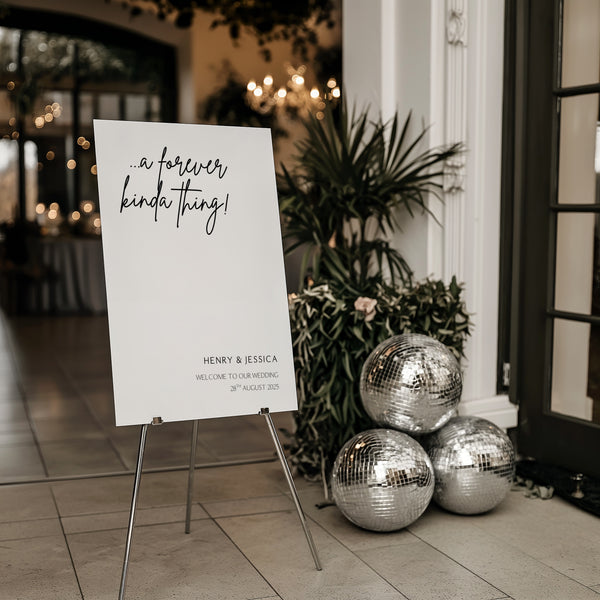a forever kinda thing wedding welcome sign personalised - sophisticated black text "a forever kinda thing" with custom name and date, on a simple white background, giving that timeless, chic wedding aesthetic.