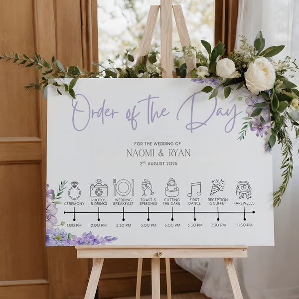 lilac floral order of the day board for weddings - a personalised order of events sign, with a crisp white background and sophisticated black text, adorned with lilac and lavender florals.