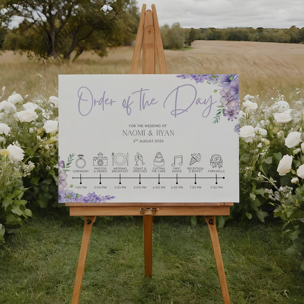 lilac floral order of the day board for weddings - a personalised order of events sign, with a crisp white background and sophisticated black text, adorned with lilac and lavender florals.